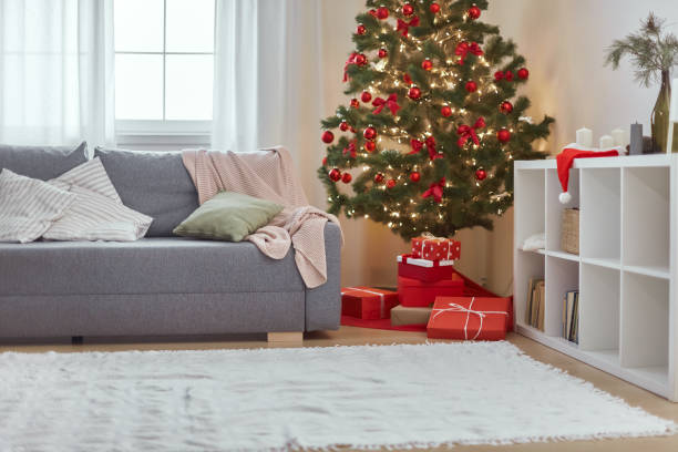 istock Christmas Home Interior. Stylish Living Room With Christmas Tree, Sofa and Gift Boxes With Presents 1348058024