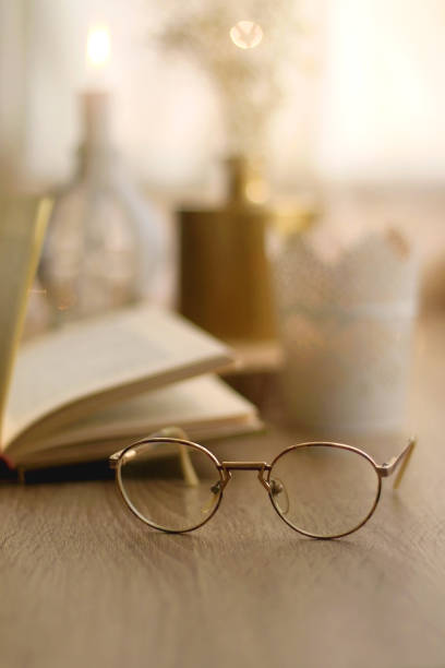 istock Book, Reading Glasses and Candles 1348059432