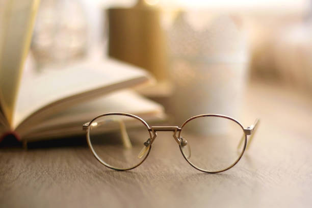 istock Book, Reading Glasses and Candles 1348059451