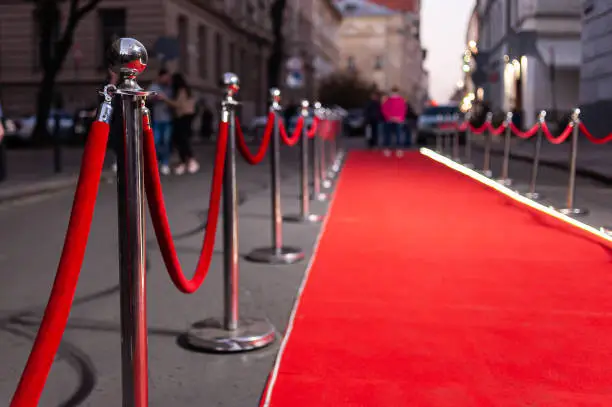 Photo of Red Event Carpet, Stair and Gold Rope Barrier Concept of Success and Triumph