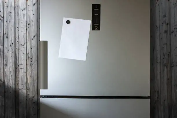 Empty Paper Sheet On Fridge Door - Infront Of Wooden Wall