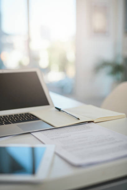 Shot of various items on a desk in an empty modern office