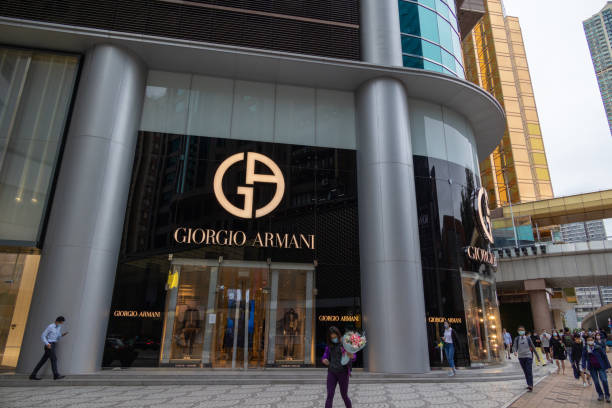 Hong Kong - October 22, 2021 : People walk past the Giorgio Armani in Canton Road, Tsim Sha Tsui, Kowloon, Hong Kong.