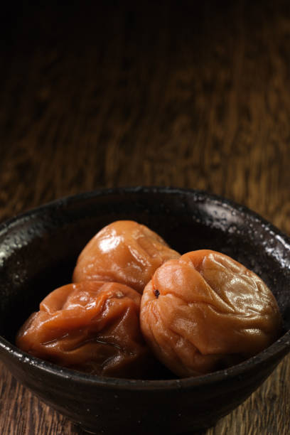 istock Japanese salt plums on wood background 1348072397