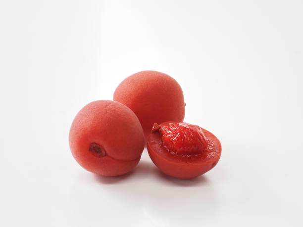 istock Japanese salt plums on white background 1348072422