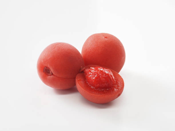 istock Japanese salt plums on white background 1348073276