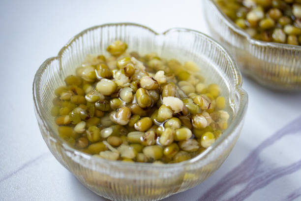 istock Green beans boiled sugar in a glass cup on a gray background 1348076443