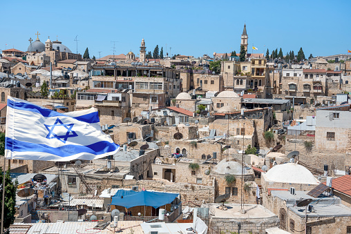 Jerusalem, Israel - October 22, 2021; An Israeli flag blows in the wind in the Old Town of Jerusalem.