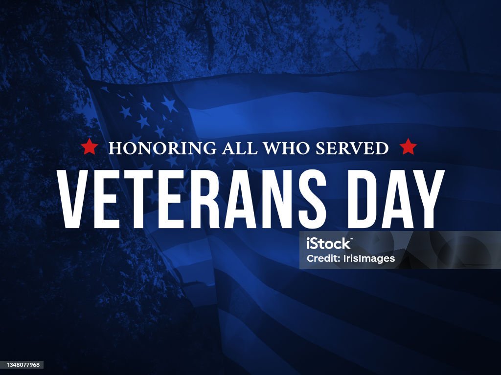 Veterans Day - Honoring All Who Served Holiday Card with Waving American Flag Over Dark Blue Background Veterans Day - Honoring All Who Served Holiday Card with Waving American Flag Over Dark Blue Background Texture US Veteran's Day Stock Photo