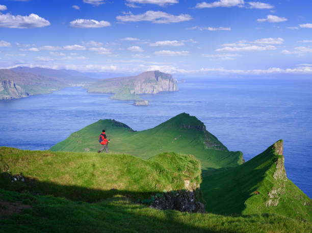 Hiking in Mykines, Faroe Islands Hiking on Mykines Island overlooking the Vagar and Tindholmur, Faroe Islands mykines faroe islands photos stock pictures, royalty-free photos & images