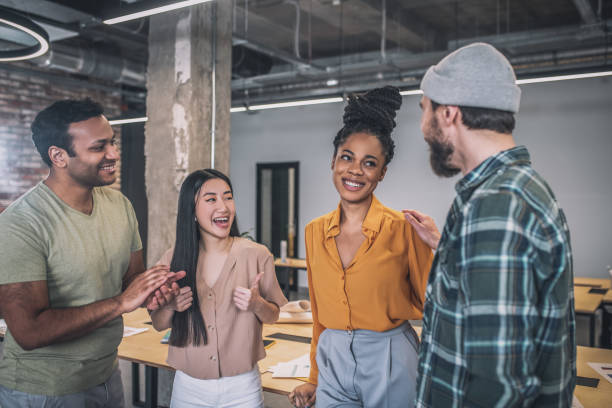 istock Young colleagues congratulating each other on victory 1348082376