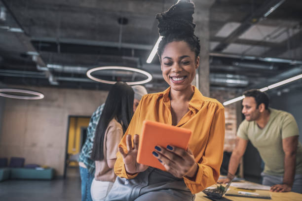 istock Smiling african american girl with tablet 1348082459