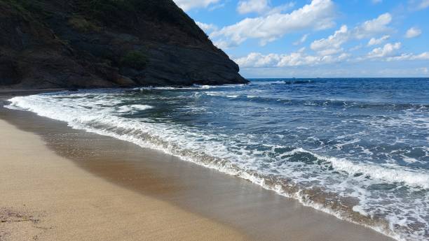 istock waves hitting the beach in the evening 1348083327