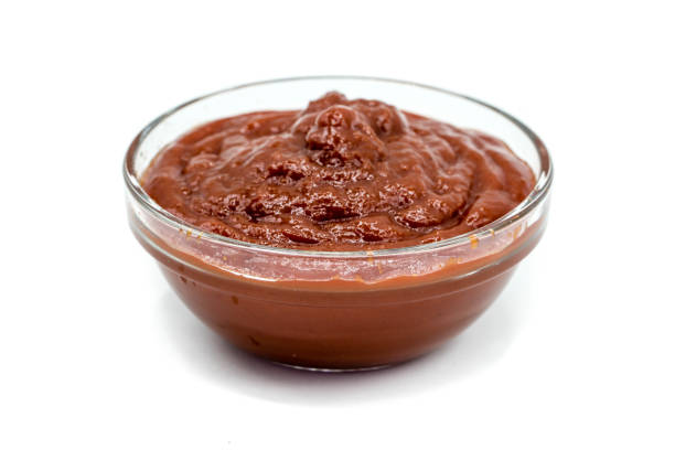 istock Ketchup in glass bowl isolated on white background 1348084804