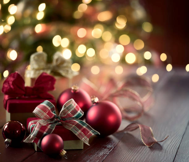 istock Elegant Christmas Decorations against and Christmas Tree Background 1348085239