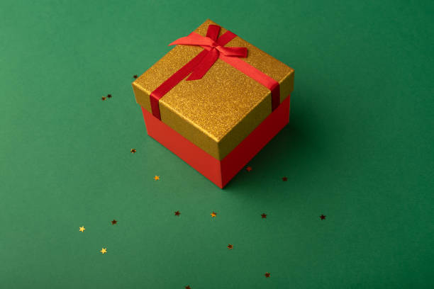istock Gift box on a green background with stars. 1348086188