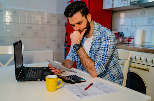istock Worried man calculating family budget 1348086221