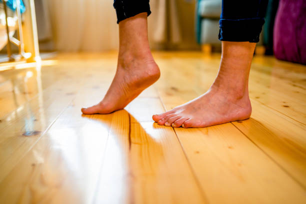 Woman walking barefoot on warm wooden floor