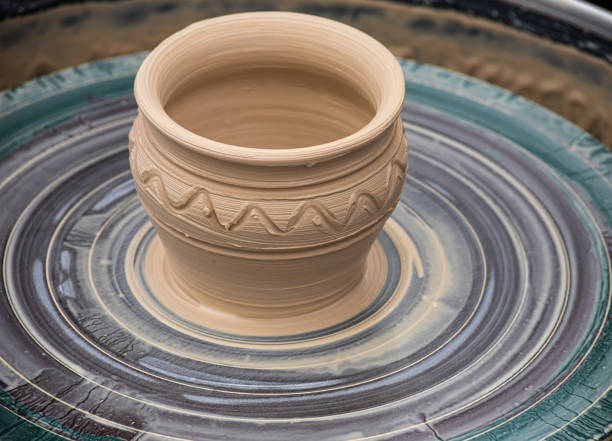 istock Master class on modeling of clay on a potter's wheel In the pottery workshop 1348088258