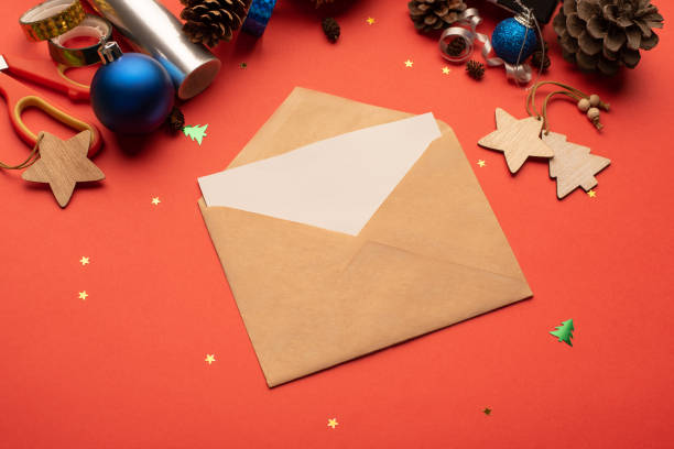 istock Craft envelope and Christmas decoration on a red background 1348089137