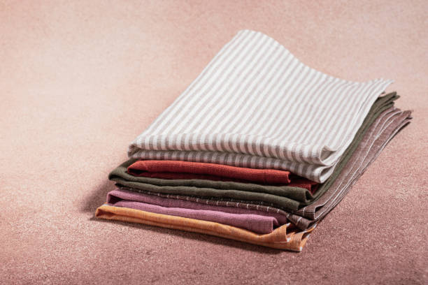 istock Stack of colored serving napkins on beige background 1348089462