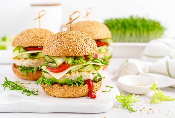istock Hamburger with grilled chicken burger, fresh cucumber, tomato, cheese and lettuce. 1348089479
