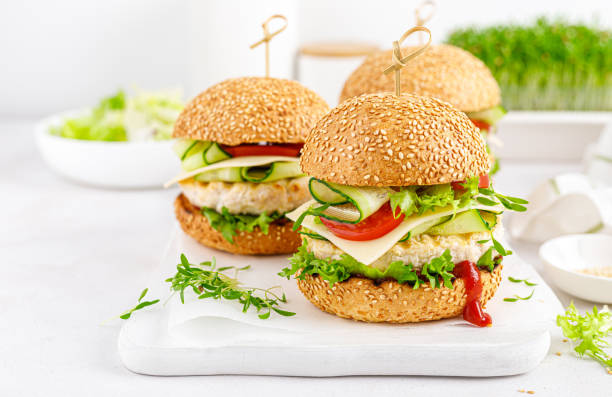 istock Hamburger with grilled chicken burger, fresh cucumber, tomato, cheese and lettuce. 1348089485