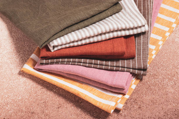 istock Stack of colored serving napkins on beige background 1348089486