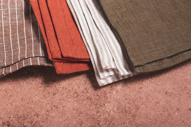 istock Stack of colored serving napkins on beige background 1348089490
