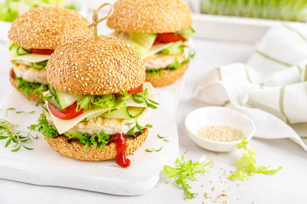 istock Hamburger with grilled chicken burger, fresh cucumber, tomato, cheese and lettuce. 1348089506