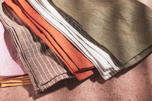 istock Stack of colored serving napkins on beige background 1348089525