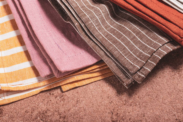 istock Stack of colored serving napkins on beige background 1348089532
