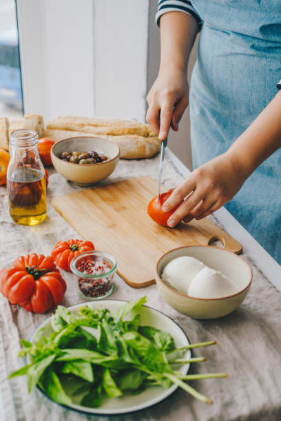 istock Woman cooking Caprese salad 1348089702