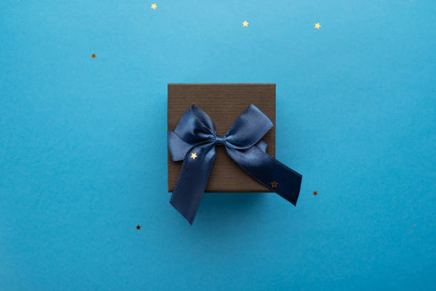istock Black gift box on a blue background with stars 1348089728
