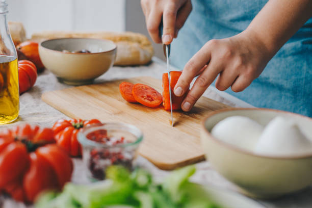 istock Woman cooking Caprese salad 1348090619
