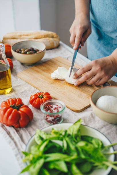 istock Woman cooking Caprese salad 1348090713
