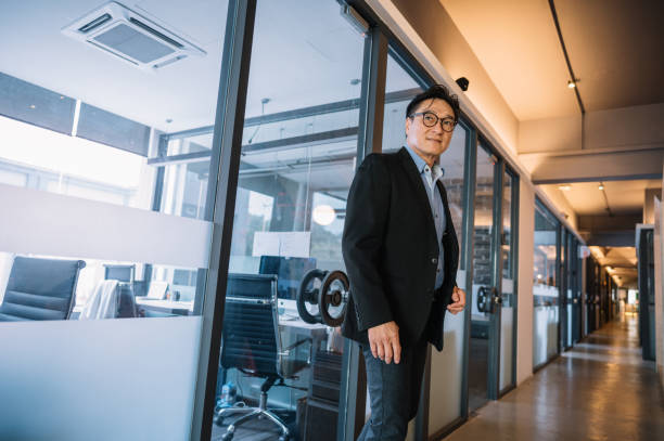 istock Successful senior Asian businessman standing in office 1348090938