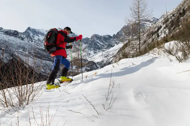 Off piste excursion. Macugnaga, Italy. Man skier with ski touring equipment. Concept of sport, freedom and adventure
