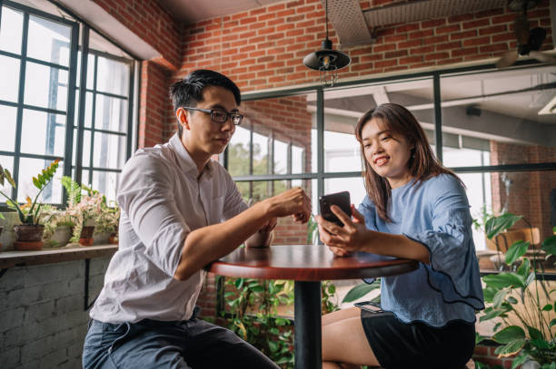 istock Colleagues talking about business strategy with smartphone at office 1348092686