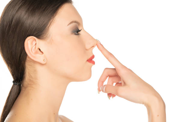 istock profile of a young woman touching her nose 1348094536