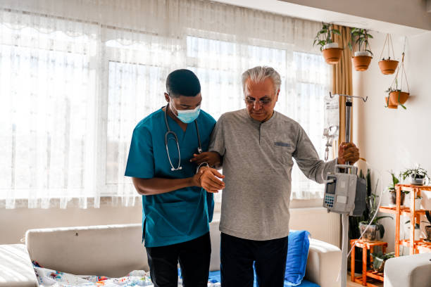 Health visitor and a  man during home visit Health visitor and a  man during home visit home caregiver stock pictures, royalty-free photos & images