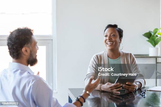 Consultant And Client In A Meeting Stock Photo - Download Image Now - Empathy, Place of Work, Listening