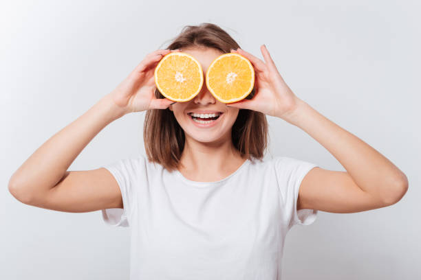 istock Pretty young lady holding orange 1348096067