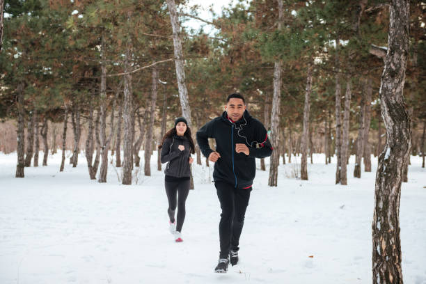 istock Happy young couple doing fit cross in the forest 1348098872