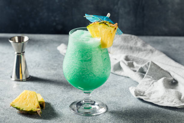 Boozy Refreshing Frozen Blue Hawaii Cocktail Boozy Refreshing Frozen Blue Hawaii Cocktail with Pineapple and Rum blue hawaiian stock pictures, royalty-free photos & images