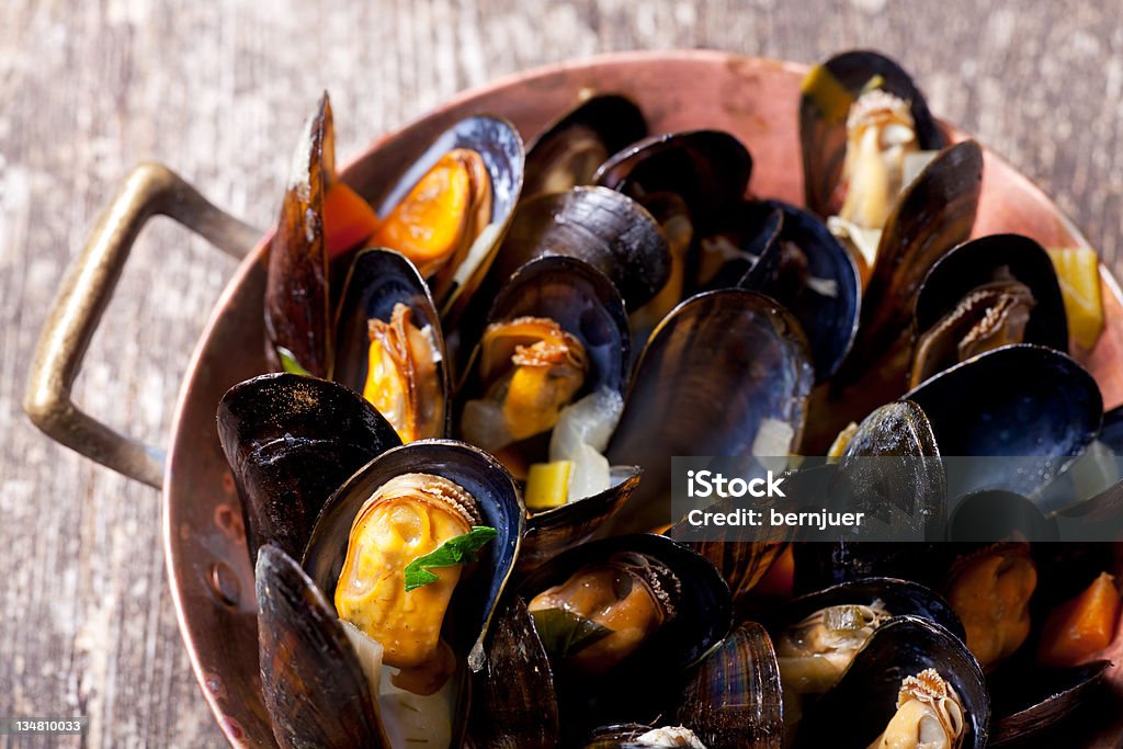mussels cooked mussels in a copper pot Animal Shell Stock Photo