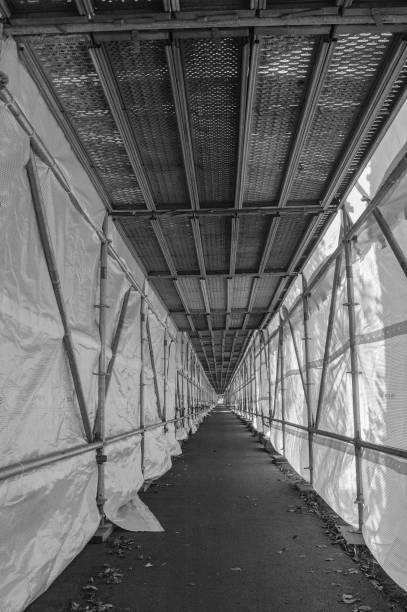 istock Scaffolding with tarpaulin over footpath 1348100530