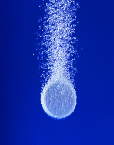 Effervescent tablet in water with bubbles