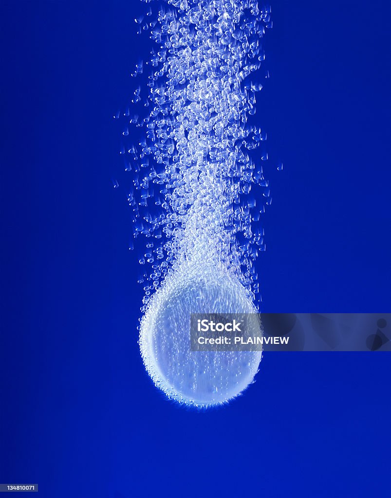 Pill in water XXL Effervescent tablet in water with bubbles Pill Stock Photo