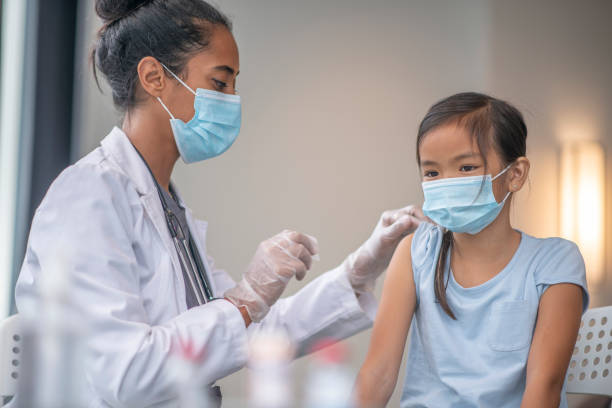 istock Preparing a Young Patients Arm for a Vaccination 1348102176